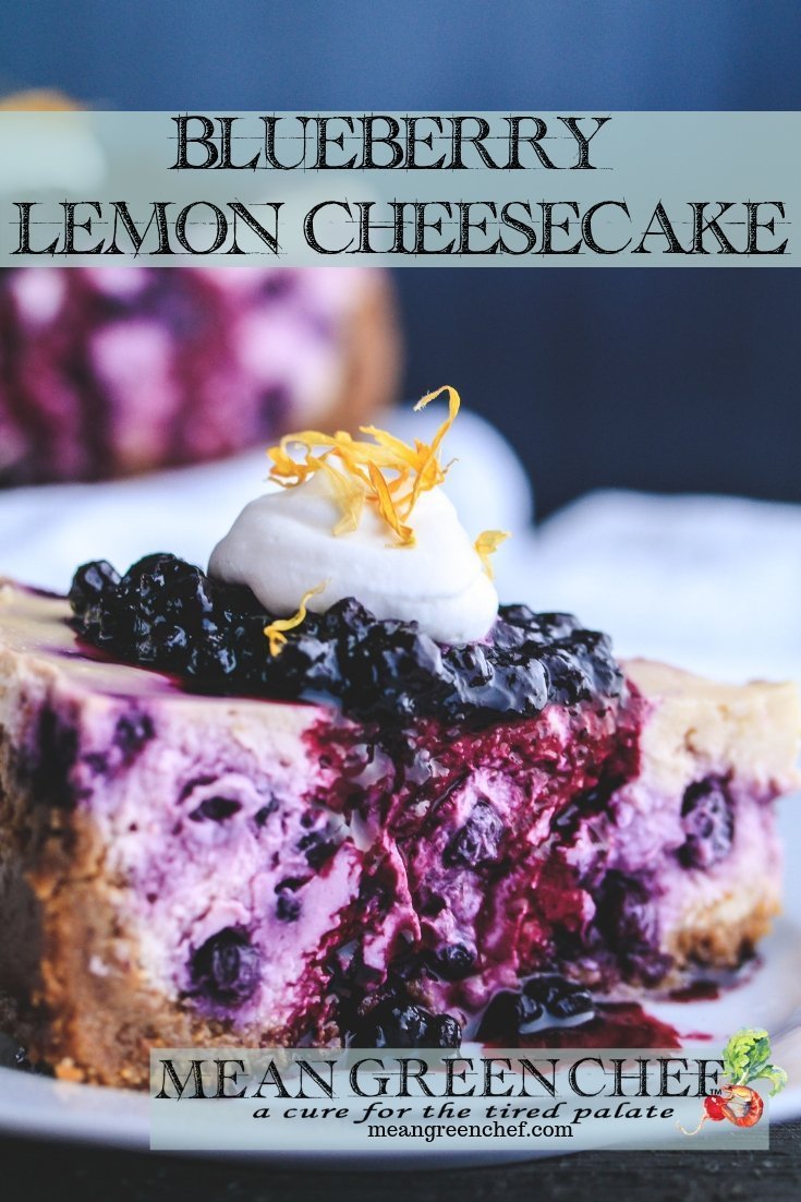 Side photo of a slice of Blueberry Lemon Cheesecake topped with blueberries and fresh whipped cream.