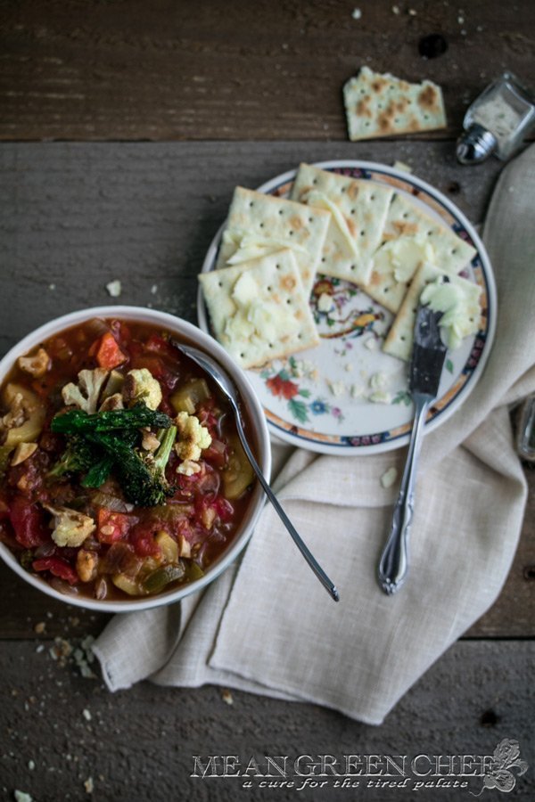 Overhead photo of a honeycomb pattern blue bowl filled with Hearty Vegetable Soup, Mean Green Chef.