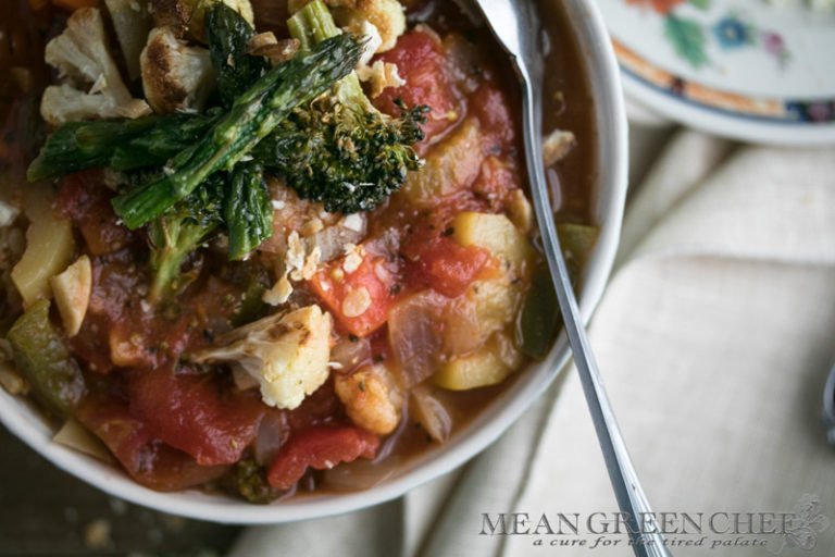Overhead photo of a honeycomb pattern blue bowl filled with Hearty Vegetable Soup, Mean Green Chef.