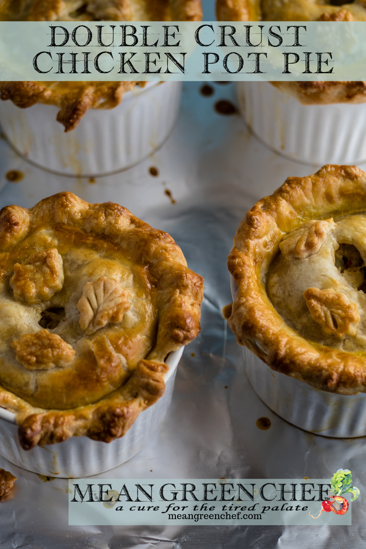 Overhead photo of four large double crust chicken pot pies in white ramekins on a baking sheet lined with foil. Mean Green Chef