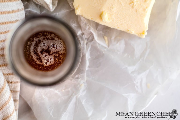 Overhead photo of Brown Butter in a decanter on a sheet of wrinkled up parchment paper. Mean Green Chef