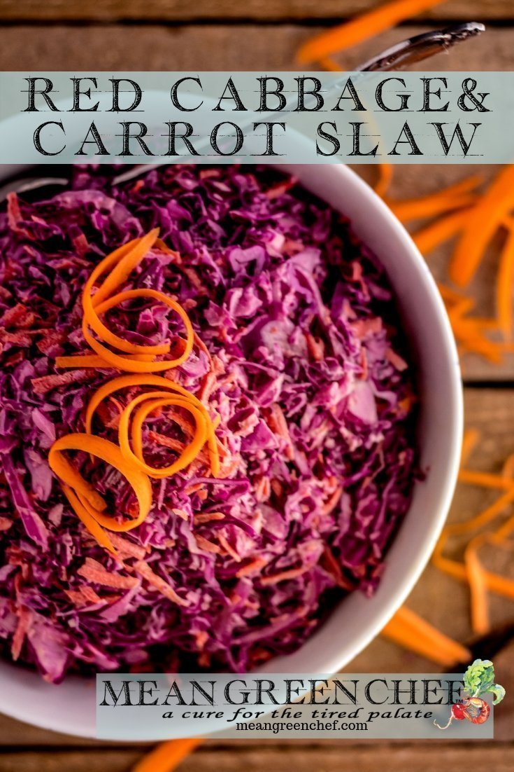 Overhead photo of Red Cabbage and Carrot Slaw in a large hit bowl with shredded carrots on a wooden background. Mean Green Chef