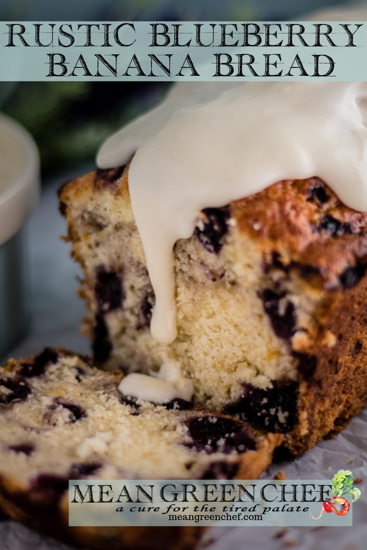 Side photo of Rustic Blueberry Banana Bread with a lush vanilla glaze dripping down a freshly sliced loaf. Mean Green Chef