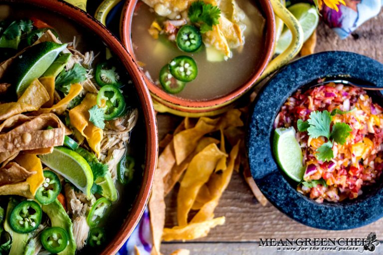 Overhead photo of Mexican Tortilla Chicken Soup Recipe in terracotta pot and bowls with crispy tortilla strips