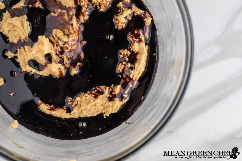 Ingredients for Best Ever Molasses Cookies brown and white sugar beaten with eggs and molasses in a large glass bowl. Mean Green Chef