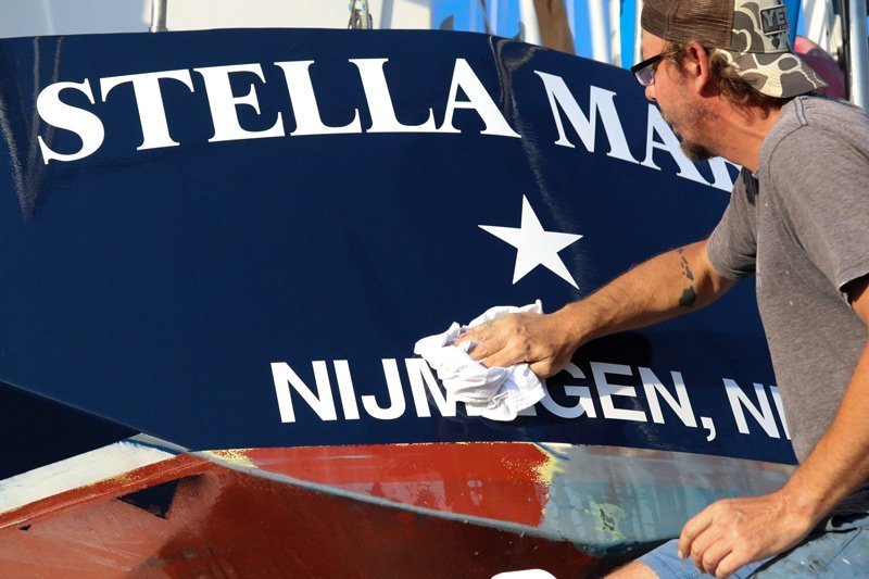 Craig Greven polishing Stella Maris his family sailboat.
