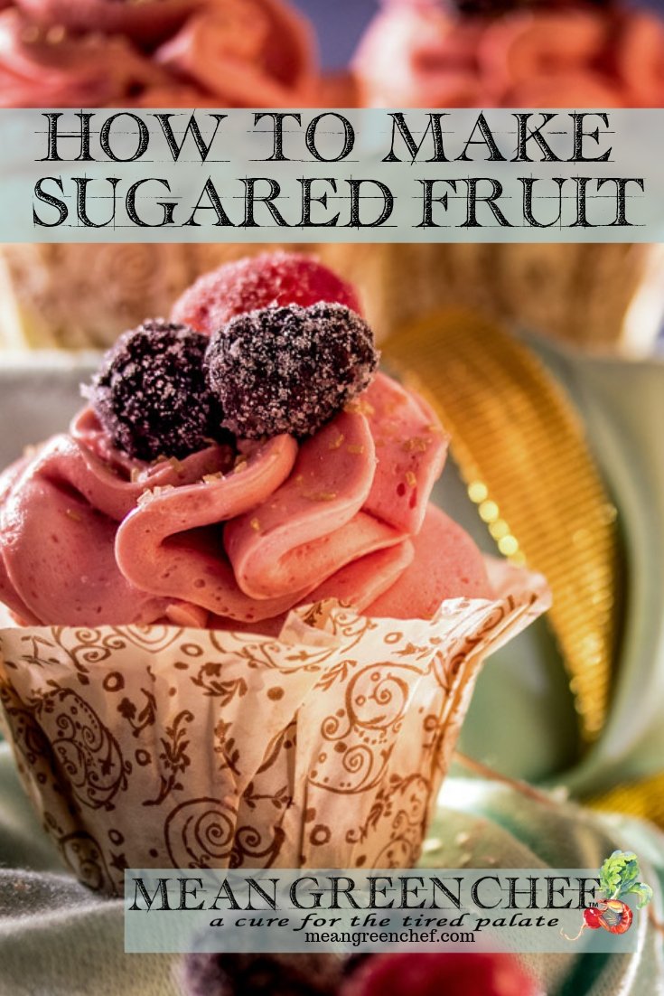 Side photo of a Pink Champagne Cupcake decorated with sugared raspberries and blackberries.