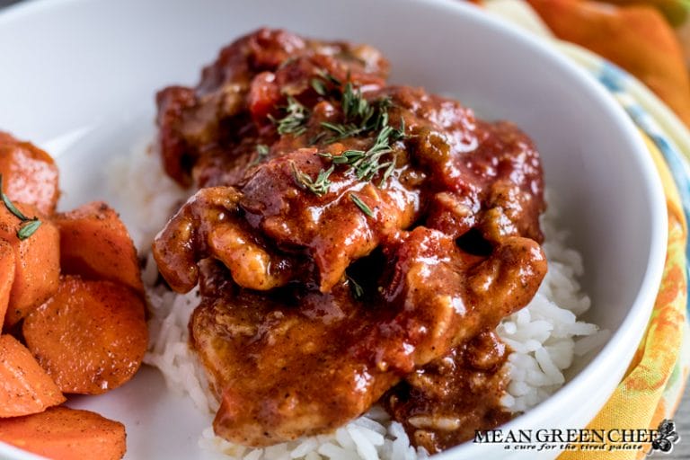 Overhead photo of Chicken Pierre in a white bowl with roasted honey carrots.