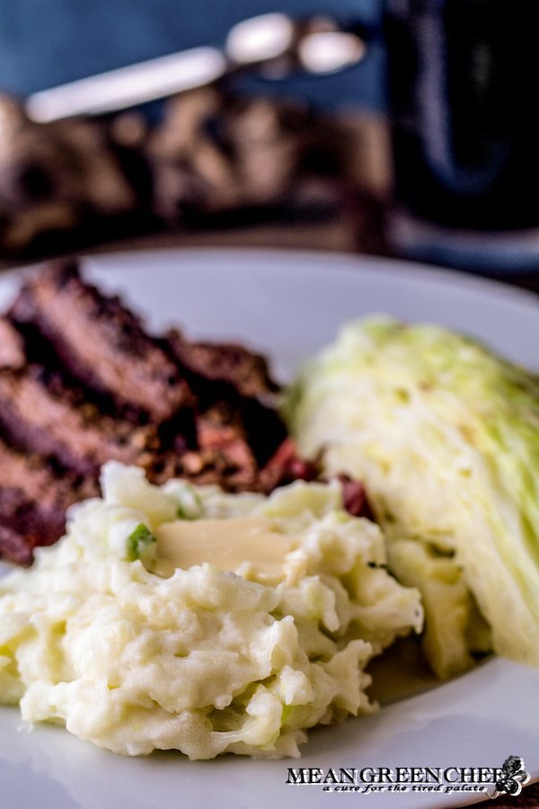 Plate of Traditional Irish Colcannon, Guinness Braised Corned Beef + Cabbage with stout.