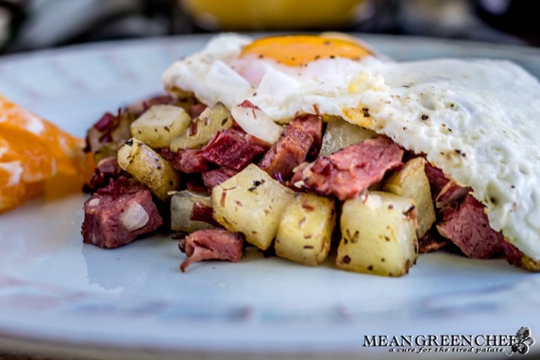 Overhead shot of Restaurant Style Corned Beef Hash topped with sunny side up eggs.