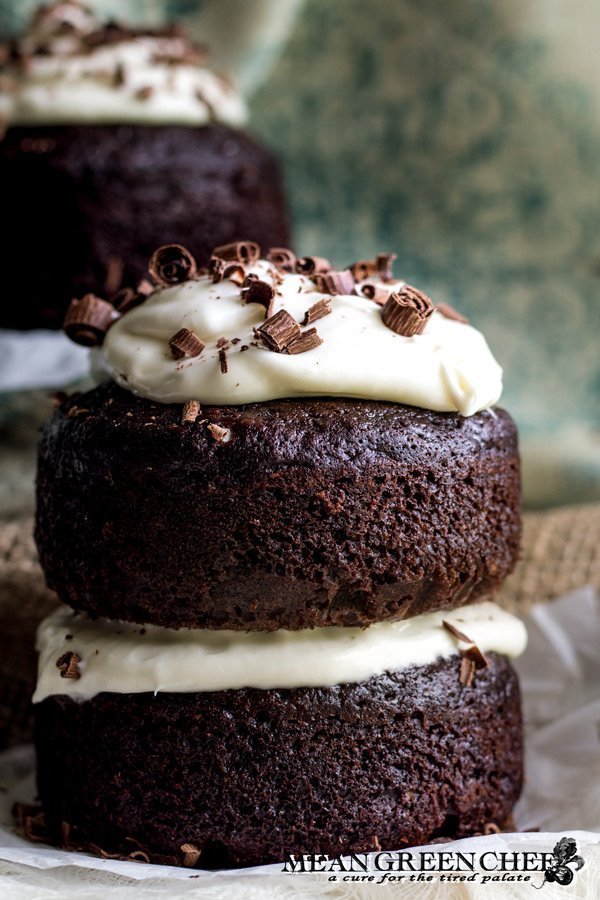 Side photo of Guinness Chocolate Cake with chocolate shavings sitting on parchment paper.