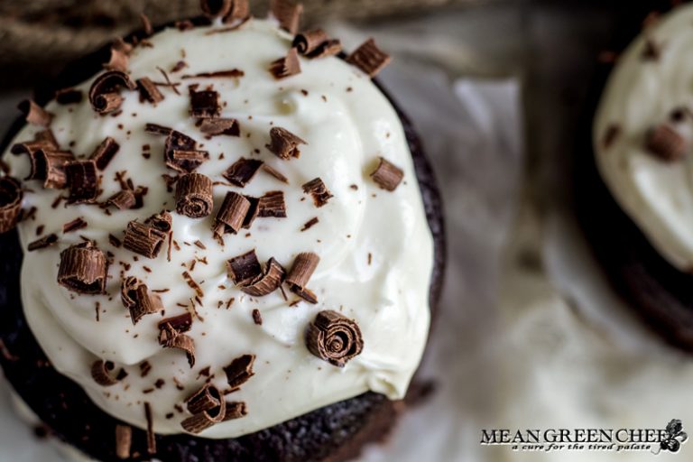 Overhead photo of Guinness Chocolate Cake with chocolate shavings sitting on parchment paper.