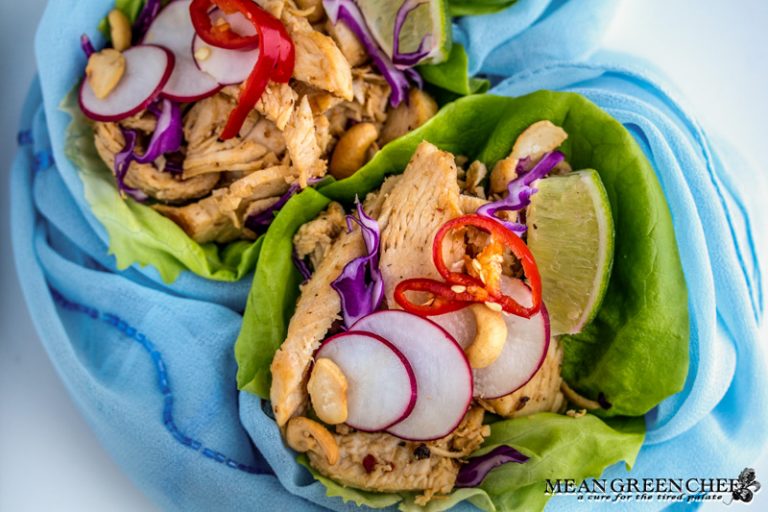 Thai Chicken Lettuce Wraps on a white background with Prik nam pla.
