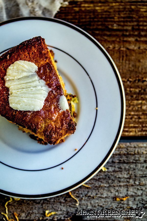 Overhead shot of a slice of triple layered corn bread being served with black bean soup.