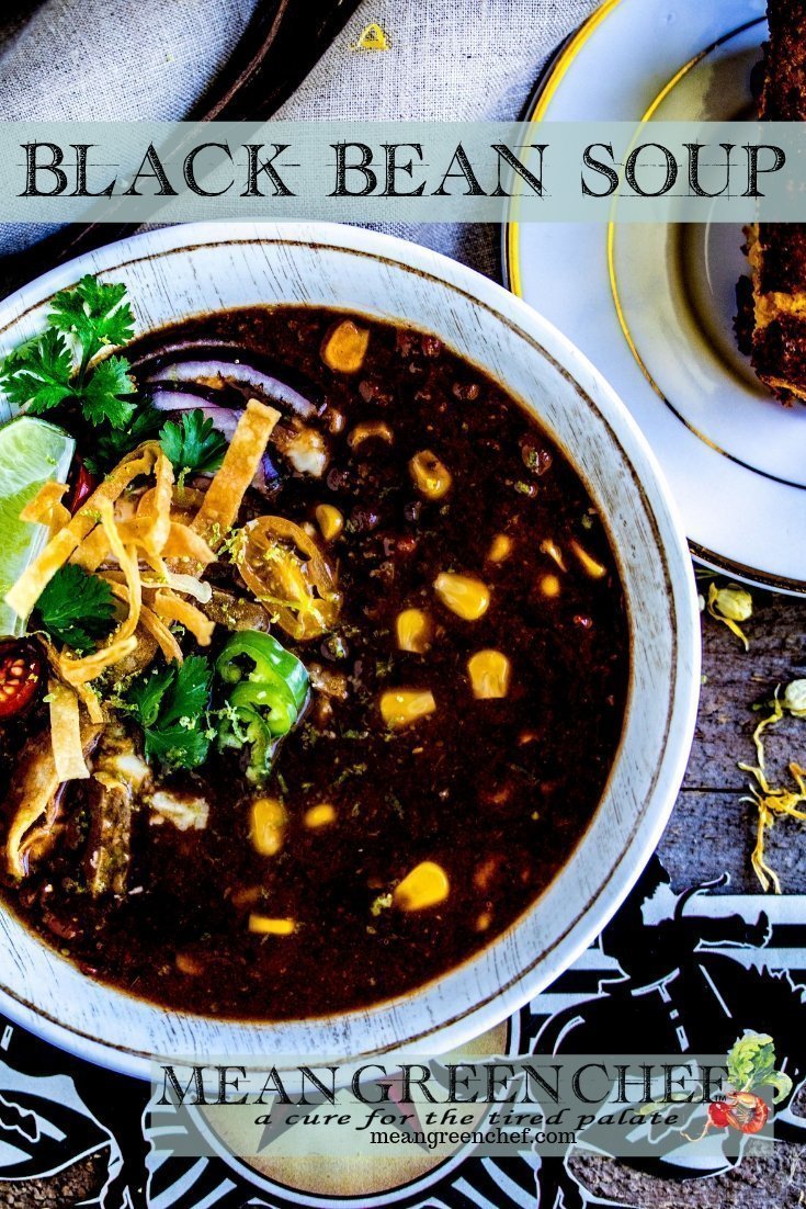 Bowl of Black Bean Soup garnished with crispy tortilla strips, jalapenos and cilantro.