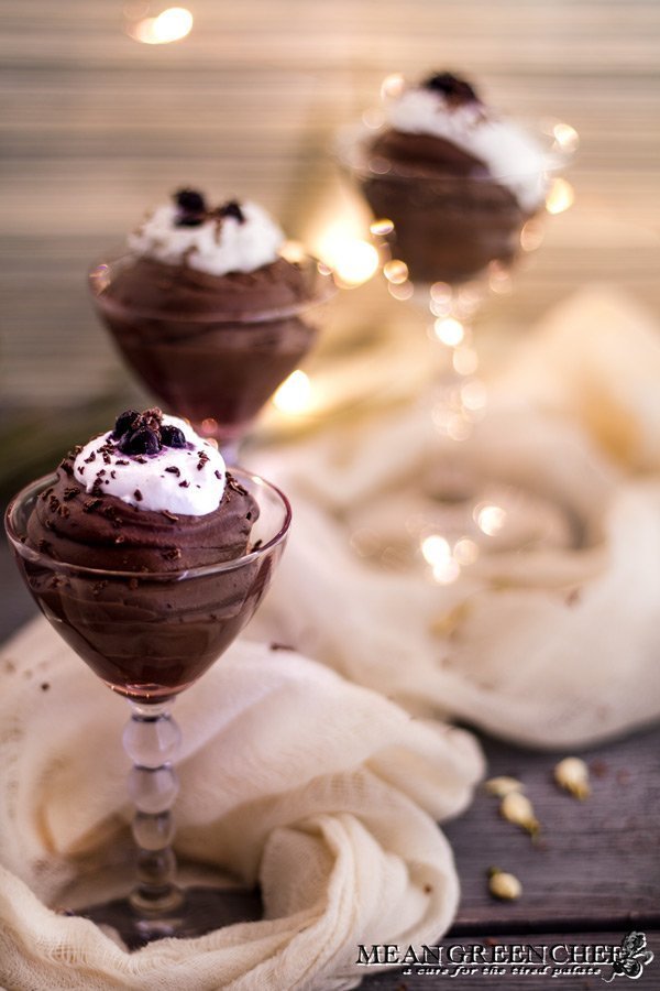 Rich Chocolate Creme Patissiere Pastry Cream piped into glasses and topped with whipped cream and blueberries.