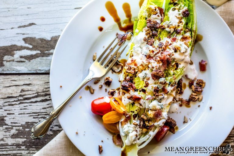 Buttermilk Blue Cheese Dressing poured over a Romaine Wedge Salad with bacon and balsamic vinaigrette.
