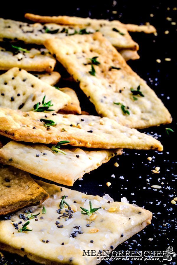 Close up of Herbed Crackers on a black background.