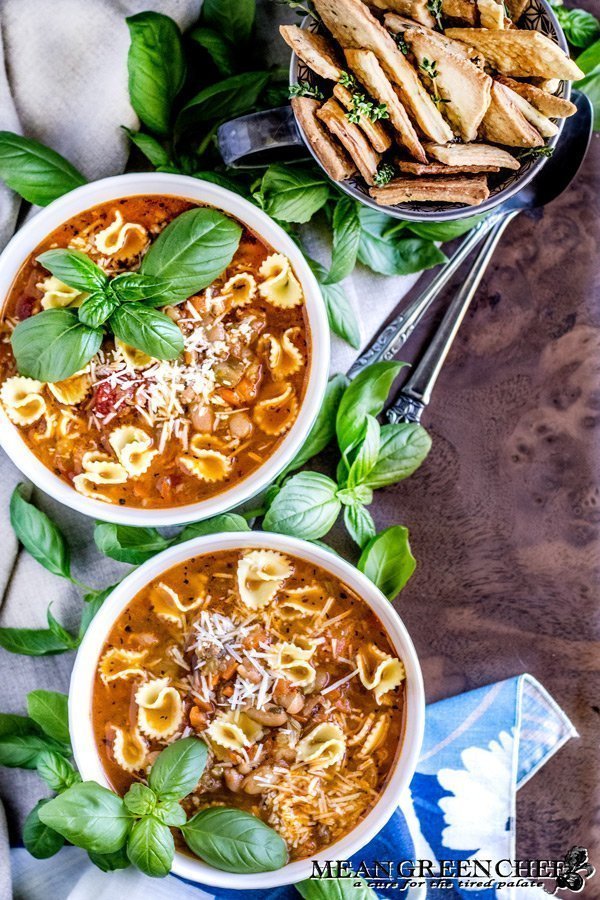Two bowls of Pasta e Fagioli with crackers.